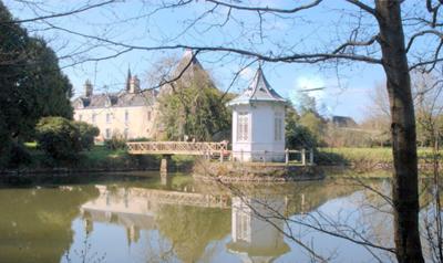 view of manoir from across the hand built carp lake