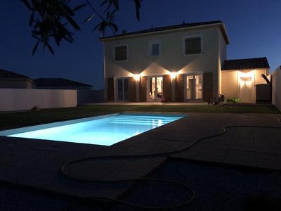 Villa and pool at night