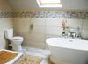 lucury bathroom with oversize rainwater sower, double vanit, loo and free-standing plunge bath