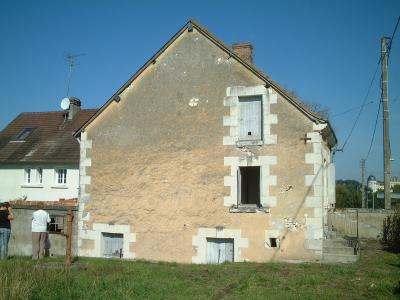 side view of house and garden with chateau in distance